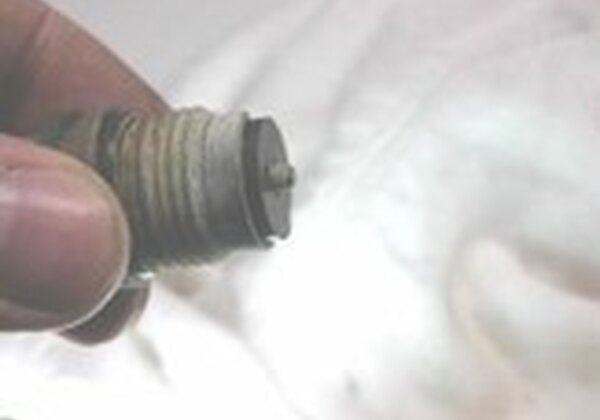 Close-up of a worn tap washer being inspected during a plumbing repair